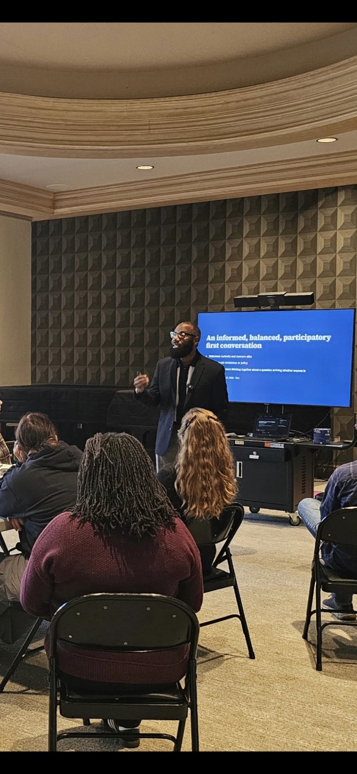 Participants engaged in Roy McCloud's AI discussion at the Flint School of Performing Arts