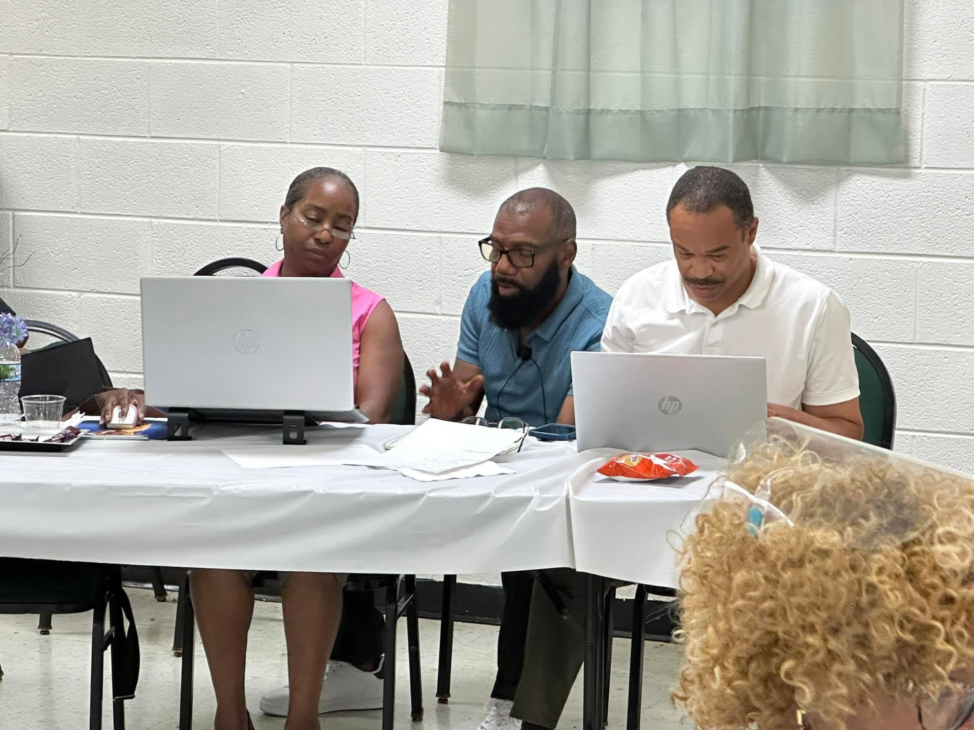 Workshop participants working together on laptops with Roy's guidance